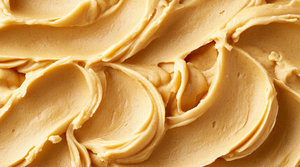 Creamy peanut butter texture in warm golden tones forms a smooth, appetizing background ideal for sweets branding, bakery advertising, food design, and dessert visuals