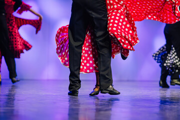 Vibrant Latvian folk dancers in traditional attire showcase dynamic movements on stage, celebrating cultural heritage and artistic expression