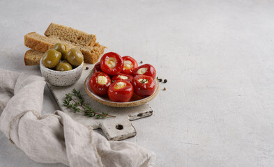 Cheese filled cherry peppers on light background in ceramic plate, copy space. Local name peynir dolgulu kiraz biberi