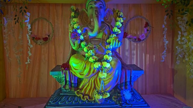 Lord Ganesha Idol with Decorative Lights and Flowers Hindu Festival Background India