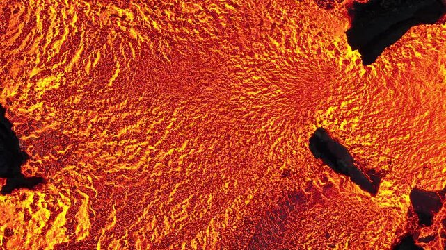 Aerial view of molten lava flow displaying a mesmerizing pattern of orange and black hues, solidifying in the landscape, Grindavik, Grindavikurbaer, Iceland.