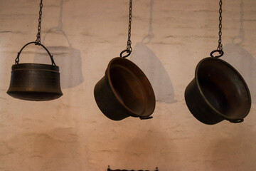 three old pots hanging with dramatic lighting