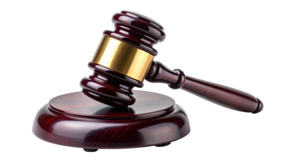 Wooden mallet with brass ring rests on matching circular base, isolated on black