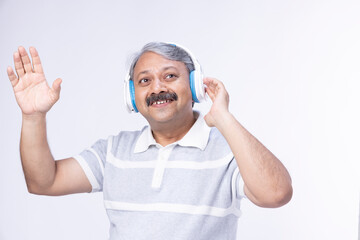 Enjoying the music. Attractive man is smiling while wearing headphones.
