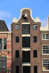 Obraz premium Brown Brick Building Facade with Clock Gable in Amsterdam, Oude Turfmarkt Street, Netherlands