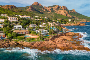 Aerial view of the village of Antheor, with the iconic red rocks of the Esterel Massif at sunset, French Riviera