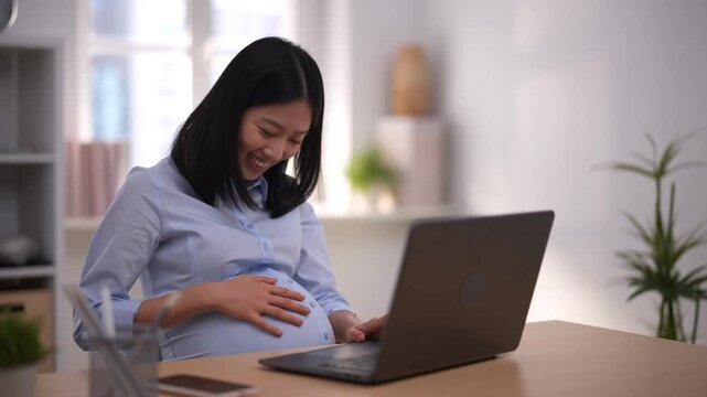 A happy pregnant woman smiling and working with a laptop Stock Video