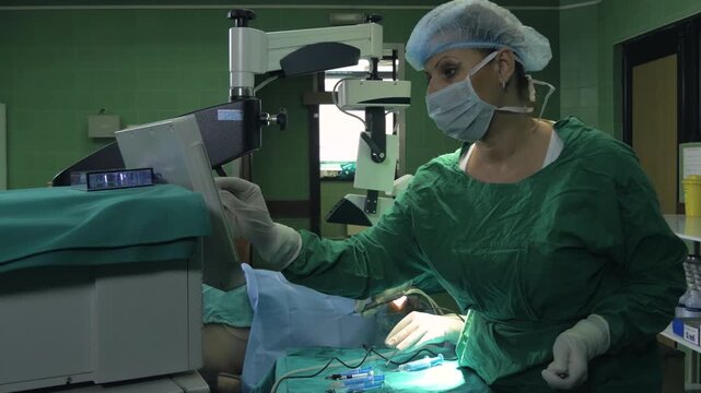 Surgeon performing cataract surgery on a patient in operating room.