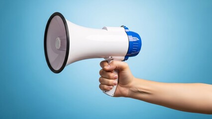 Hand holding a white and blue megaphone against a light blue background for advertising promotion or public announcement concept