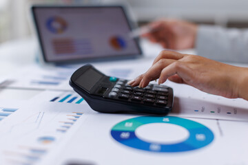 Female Professional Using Calculator for Business Budget Analysis
