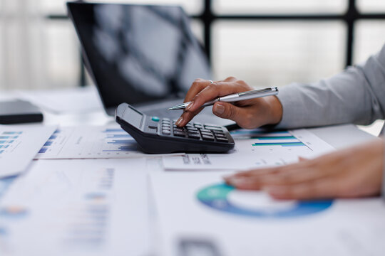 Business woman analysis summary graph reports of business operating expenses and work data about the company's financial statements.
