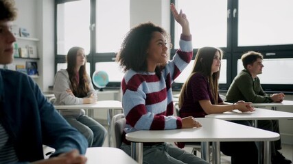 Confident teen student standing in modern classroom. - Powered by Adobe