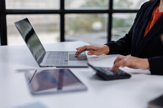 Calculator, Business woman of professional calculator business estimate the company budget, using calculator in the office room.
