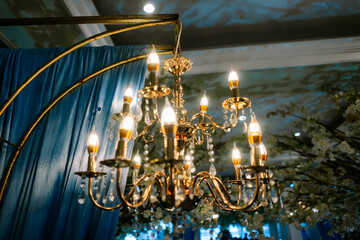 Elegant Golden Chandelier with Crystal Decor at Festive Event