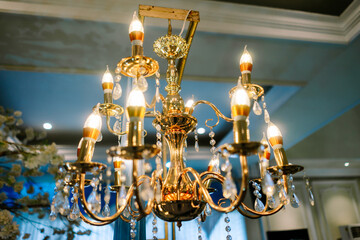 Elegant Golden Chandelier with Shining Crystal Accents and Candle Bulbs