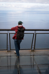 Tourist woman enjoying cabo girao skywalk ocean view. Madaira, Portugal