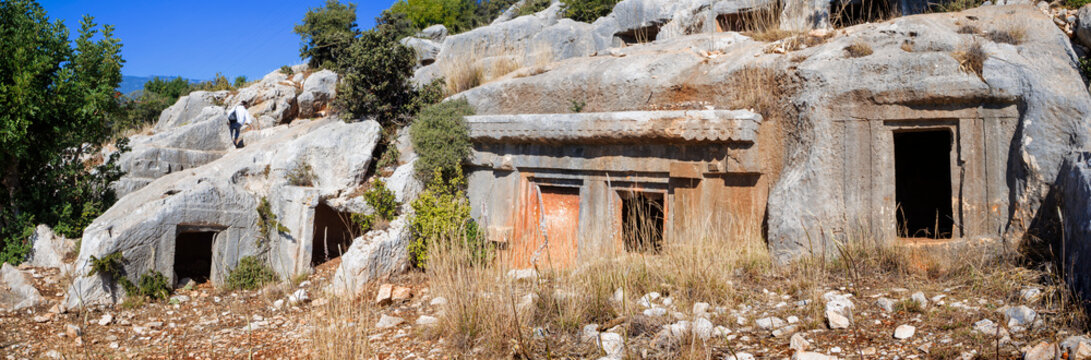 The ancient Lycian rock tombs of Demre (Myra) are carved into the red cliffs: facades with Doric columns and pilasters over terraces, a classic symbol of Lycian culture in Turkey. 