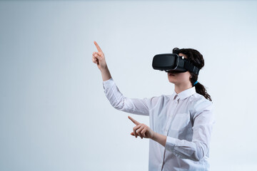Woman using virtual reality headset and interacting with advanced digital interface through hand tracking technology on clean white studio background