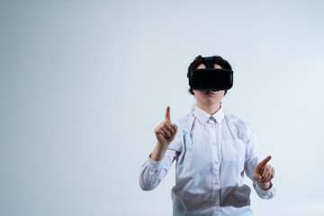 Woman wearing virtual reality headset and selecting digital elements with finger using futuristic human computer interaction technology