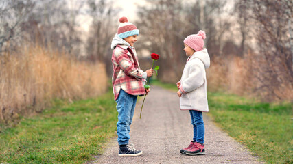 happiness on the romantic valentines day, cute children with a red rose