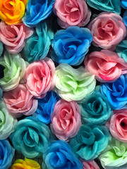 bunch of colorful fabric roses background 