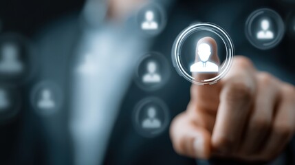 Business professional points at digital user icons on a screen during a meeting in an office setting