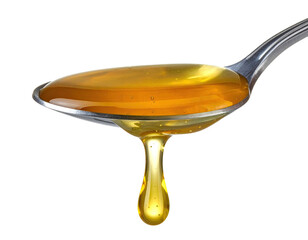 Close-up of spoon holding golden, viscous liquid, a drop falling, against a black backdrop