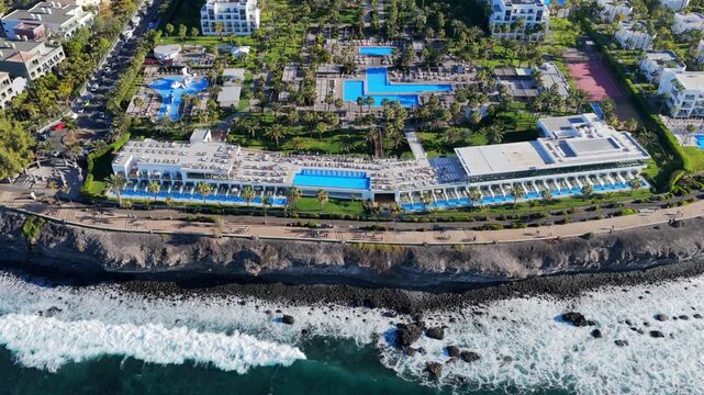 Elite Resort Horizon: 4K Aerial of the Meloneras 5-Star Hotel Strip featuring Lopesan Costa Meloneras, Baobab, Villa del Conde, and RIU Palace, Gran Canaria, Spain