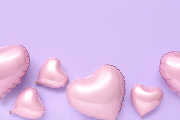 Pink heart shaped air balloons on purple background
