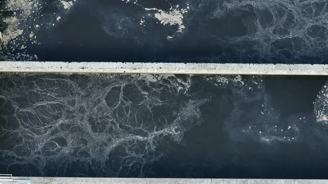 A large wastewater treatment facility featuring multiple channels of water. It showcases the technology used in urban water management.