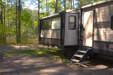 Look at a slide out extended at a campsite near a lake