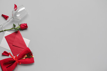 Beautiful table setting for Valentine's Day with envelope and rose flower on white background