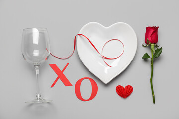Beautiful table setting for Valentine's Day with paper letters XO and rose flower on white background
