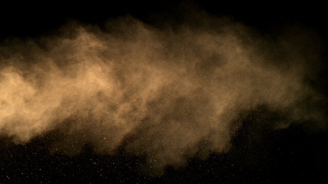 Freeze Motion Shot of Flying Sand Dust , Isolated on Black Background