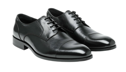 Pair of glossy black leather men's dress shoes, laces tied, angled slightly, isolated on black