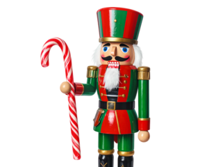 Wooden Christmas soldier figure holding candy cane, isolated on black background