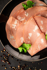 Mortadella sausage slices meat food tasty snack fresh delicious gourmet food background on the...
