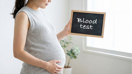 Pregnant woman holding a chalkboard with blood test text in a bright room, expecting mother prenatal care check-up, health monitoring medical examination during pregnancy, maternal healthcare concept