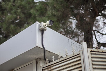 A CCTV camera on the roof of a building. Smart city concept. City safety and security.