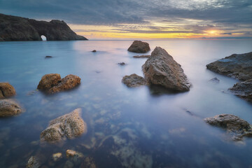 Beautiful seascape. Sea and stones on sunset