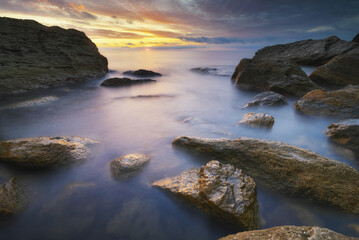 Beautiful seascape. Sea and stones on sunset