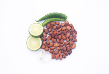 Healthy Food Elements Arranged in a Circle on a White Background. Fresh Lemons Slices, Peanuts, Onion Rings, and Green Pepper. Top View