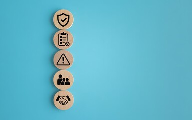 Wooden blocks with business concept icons on blue background