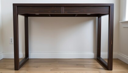 The image features a minimalist wooden desk positioned against a plain white wall in a well lit room
