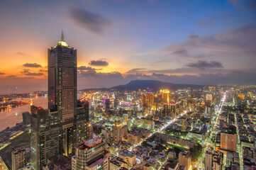Naklejka premium Aerial view of Kaohsiung 85 Sky Tower and Kaohsiung Harbor at sunset, Taiwan cityscape.