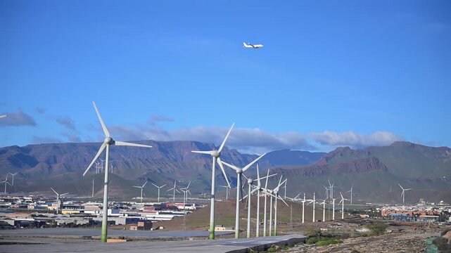 Sustainability in Motion: 4K Aerial of Passenger Aircraft Landing over the Arinaga Offshore Wind Farm and Renewable Energy Infrastructure, Gran Canaria, Spain