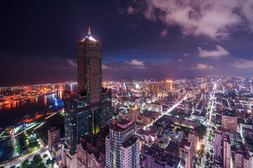 Obraz premium Aerial view of Kaohsiung 85 Sky Tower and Kaohsiung Harbor at sunset, Taiwan cityscape.