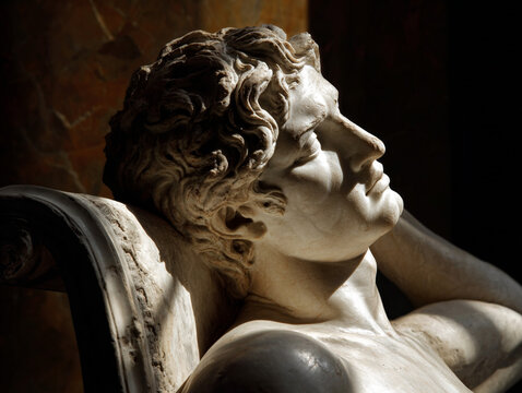 Reclining classical marble male statue amid art museum decor with soft light highlighting textures - Powered by Adobe
