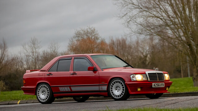 Milton Keynes,Bucks,UK - Jan 1st 2026: 1984 red Mercedes Benz 190 E  classic car driving on a British road