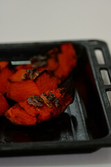 Delicious traditional roasted pumpkin slices topped with walnuts. Sustainable and natural dessert background featuring copy space for mindfulness, balance and herbal nutrition themes.